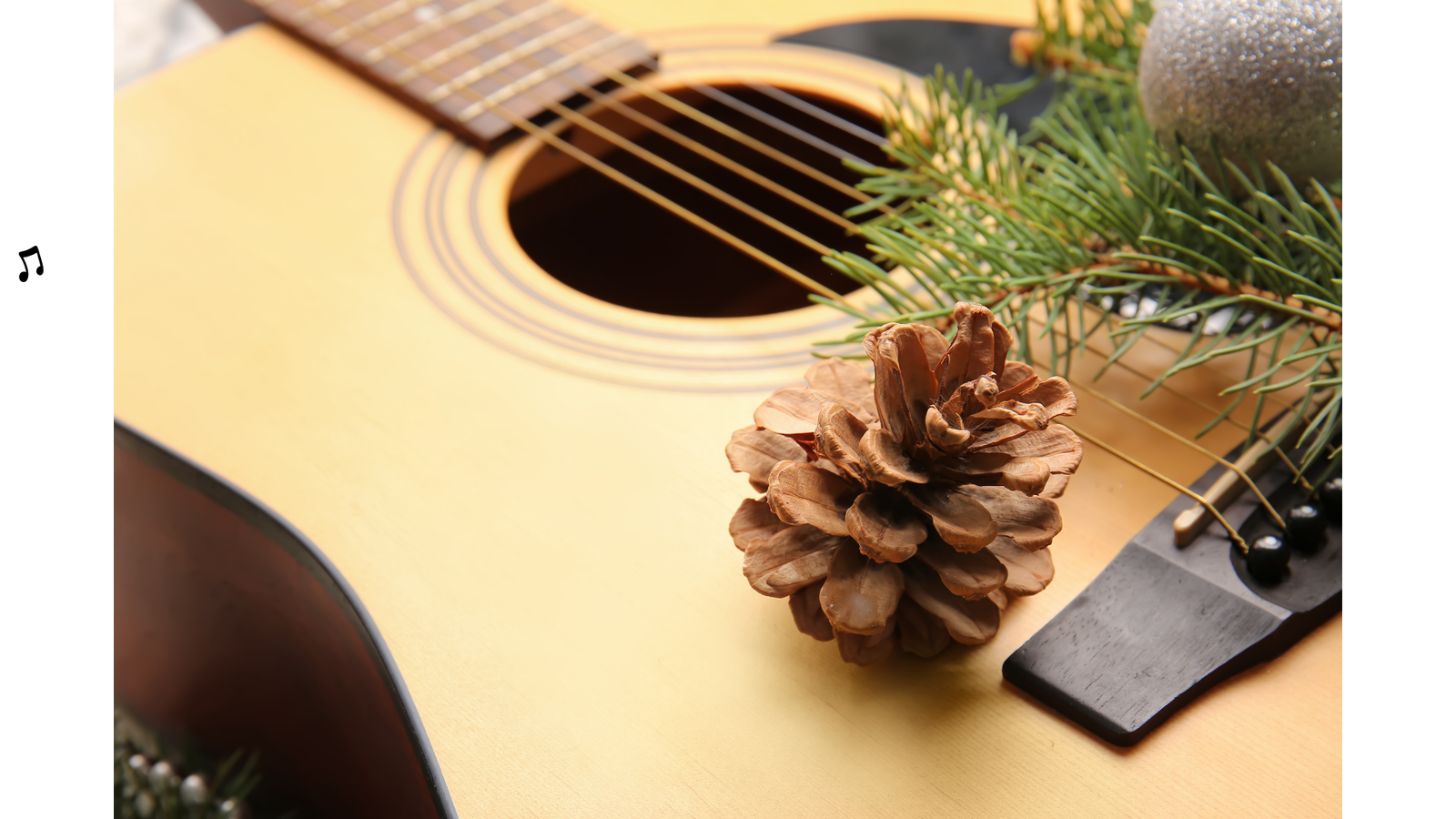 Liegende Gitarre, obendrauf Tannenzapfen und Tannenzweige